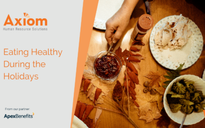 Axiom Human Resource Solutions graphic promoting healthy eating during the holidays, featuring a hand preparing food with autumn leaves and plates, emphasizing wellness amid holiday festivities.