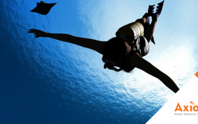 Landscaping & Field Services HCM Solutions 5 Human Capital Management Solutions for landscaping and field services Diver swimming underwater with a manta ray, Axiom Human Resource Solutions logo in the corner, symbolizing exploration and depth in HR management solutions.
