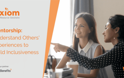 Two women engaging in a mentorship discussion, highlighting cross-cultural understanding and inclusiveness, with Axiom Human Resource Solutions branding.