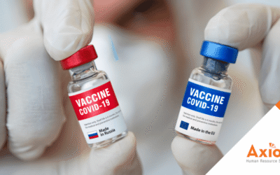Vials of COVID-19 vaccines labeled with red and blue caps, held by a gloved hand, representing vaccination options and compliance in the context of Indiana's vaccine exemption laws.