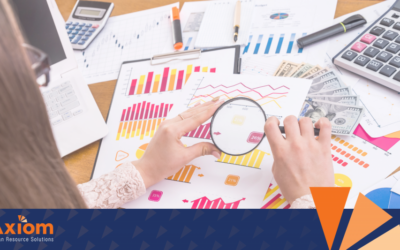 Person analyzing business data with magnifying glass, featuring charts and graphs, Axiom Human Resource Solutions branding in the corner, emphasizing HR solutions and workforce management.