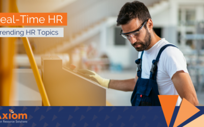 Real-Time HR graphic featuring a worker in safety gear, emphasizing trending HR topics related to employee classification and workforce management.