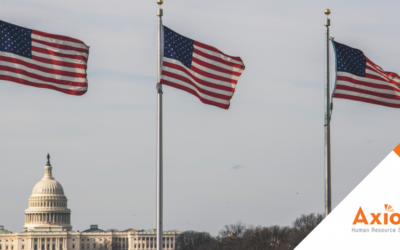 Axiom Resources 10 Three American flags waving in front of the U.S. Capitol building, with Axiom Human Resource Solutions logo in the bottom right corner, symbolizing compliance with federal employment laws.