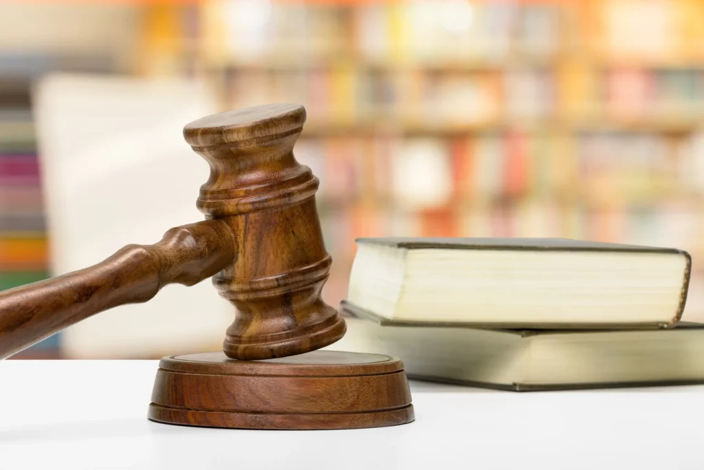 Wooden gavel and books on wooden table