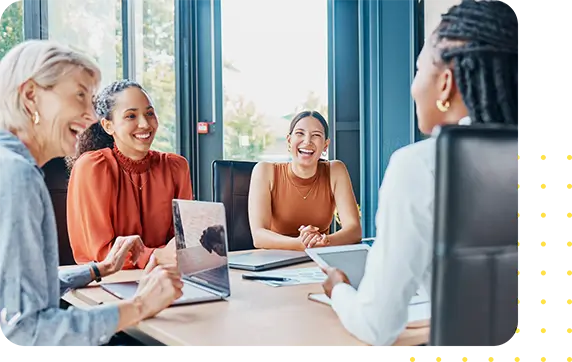 Four coworkers at a conference room table