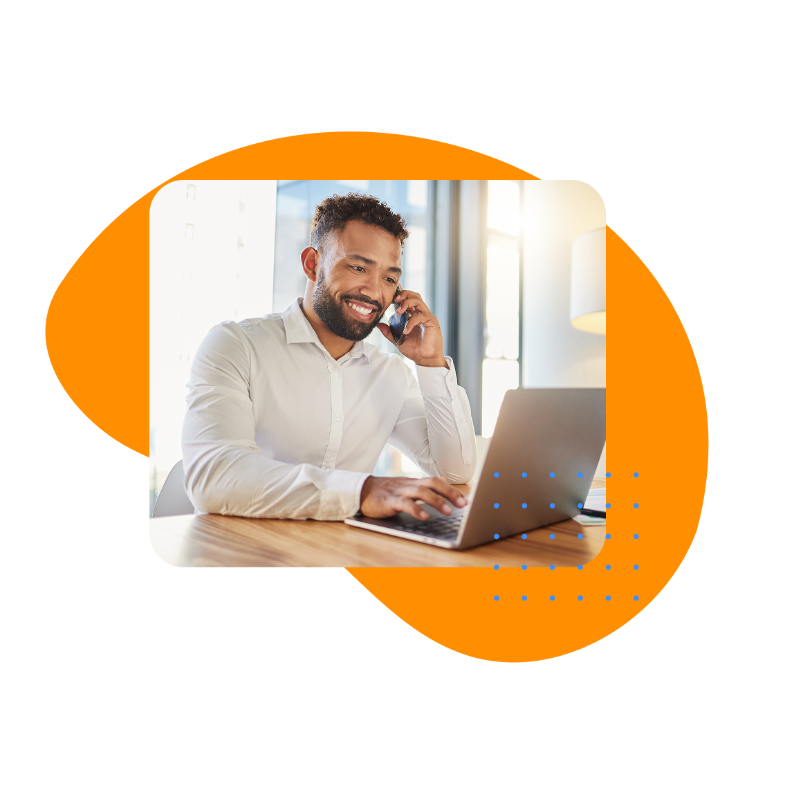 Smiling professional man on phone call using laptop at desk, representing HR solutions and workforce management in a modern office setting.